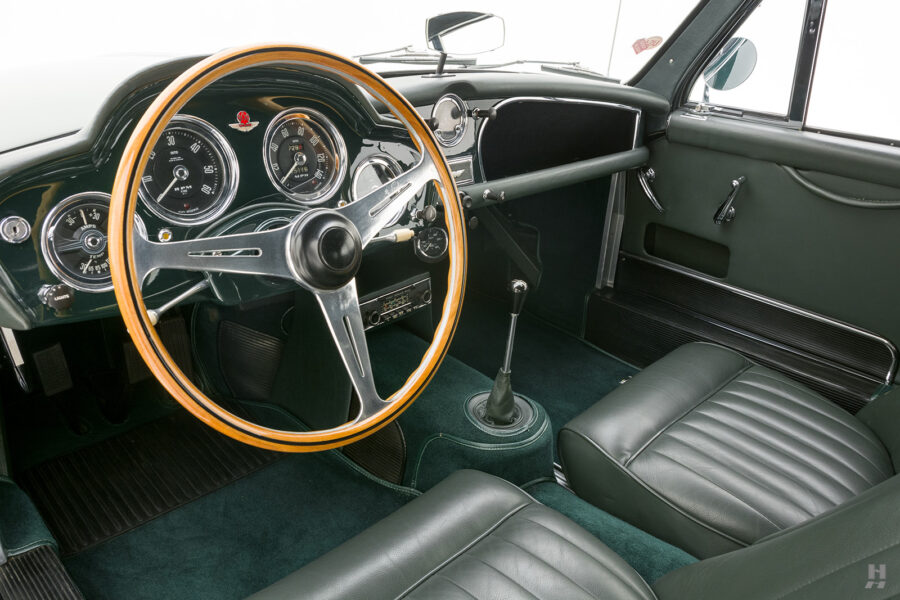 interior of old aston martin coupe for sale by hyman car dealers