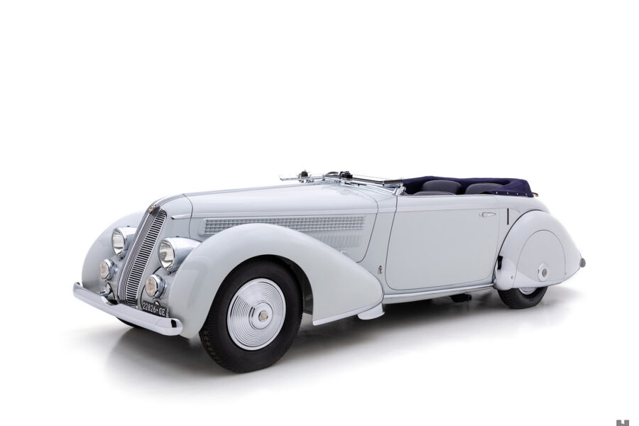 front of antique 1936 Lancia Astura Cabriolet for sale by Hyman classic car dealers